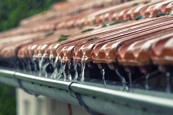 How Clogged Gutters Damage Roofs & Foundations