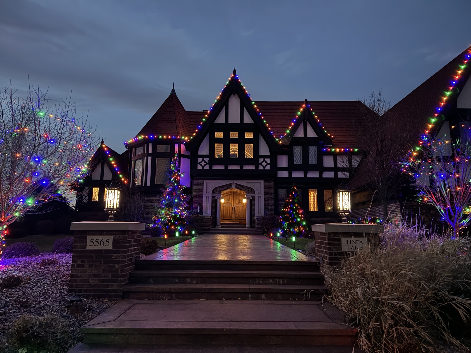 Multicolor Christmas lights on a Tudor-style home