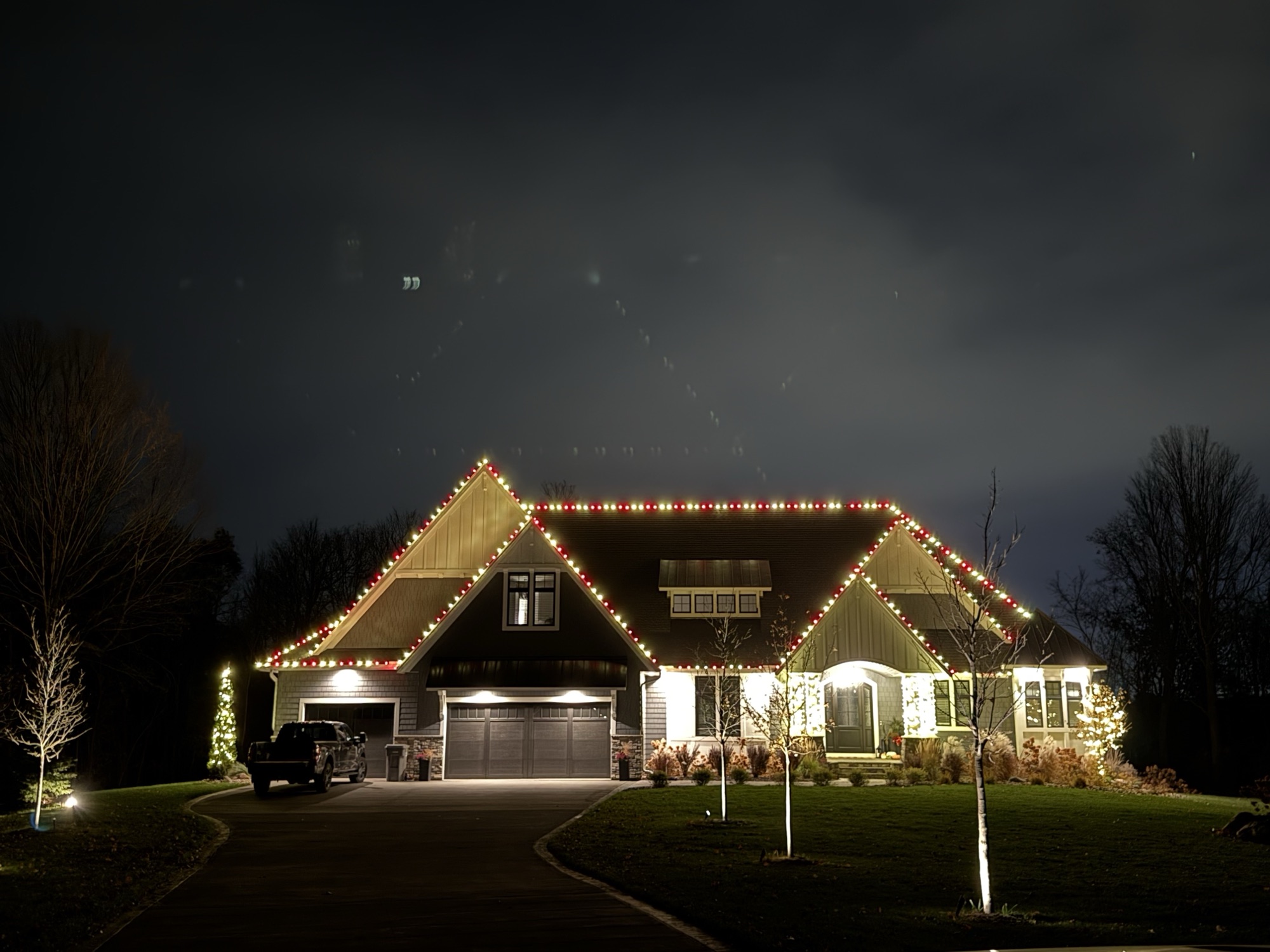 Red and white roofline Christmas lights on a home